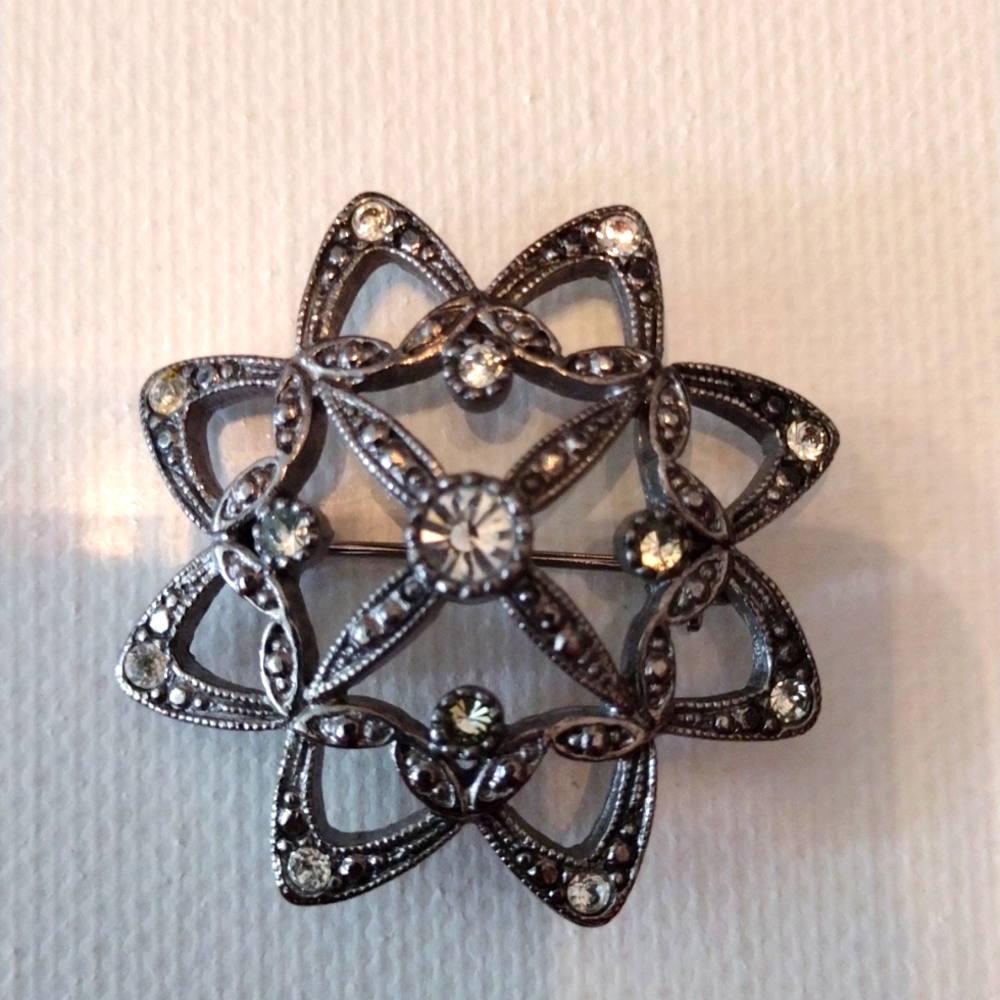 LC silver and rhinestone brooch.